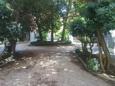 a walkway with trees on the side of a building at Dhome B&B in Rome