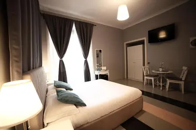 a bedroom with a bed and a window and a table at Dhome B&B in Rome