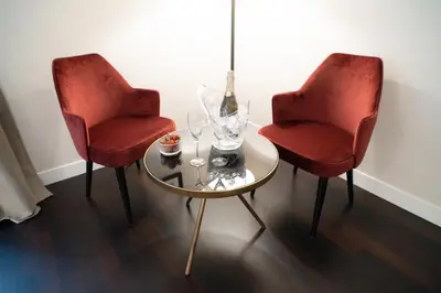 two red chairs and a table with wine glasses at Kame Hall in Rome