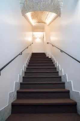 a staircase in a building with a chandelier at Kame Hall in Rome