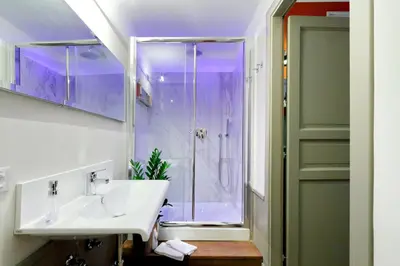 a bathroom with a sink and a shower at Piranesi Charmsuite in Rome