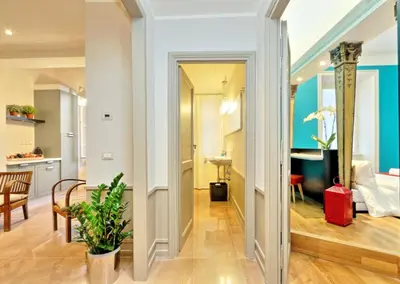a hallway leading to a kitchen and a living room at Piranesi Charmsuite in Rome
