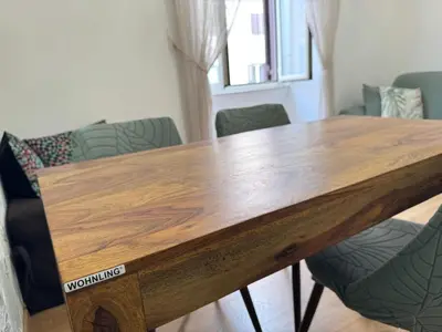 a wooden table in a room with chairs at Amedeo Apartment in Rome