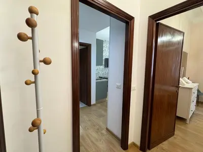 a hallway with a mirror and a door in a room at Amedeo Apartment in Rome