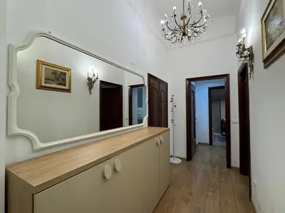 a bathroom with a large mirror and a dresser at Amedeo Apartment in Rome