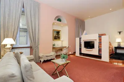 a living room with a white couch and a tv at Rome in your heart - Spagna apartment in Rome