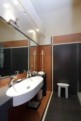a bathroom with a white sink and a mirror at Rome in your heart - Spagna apartment in Rome