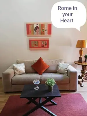 a living room with a couch and a coffee table at Rome in your heart - Spagna apartment in Rome