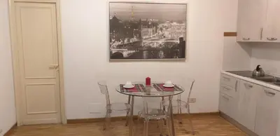 a kitchen with a table and chairs in a room at Cozy Navona Apartment in Rome