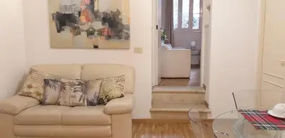 a living room with a chair and a glass table at Cozy Navona Apartment in Rome