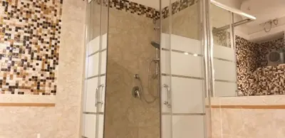 a shower with a glass door in a bathroom at Cozy Navona Apartment in Rome