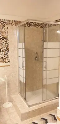a shower with a glass door in a bathroom at Cozy Navona Apartment in Rome
