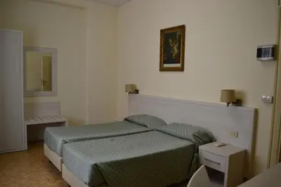a small bedroom with a bed and a mirror at Casa per Ferie Ravasco San Pietro in Rome