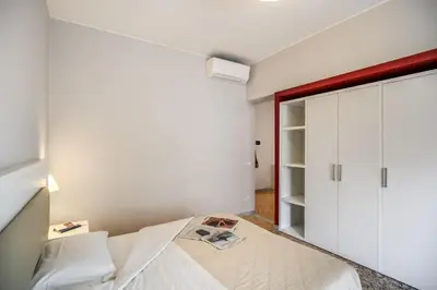 a bedroom with a bed and a closet at Casa per Ferie Ravasco San Pietro in Rome