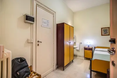 a room with a bedroom with a bed and a door at Casa per Ferie Ravasco San Pietro in Rome