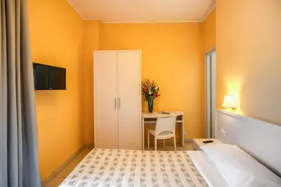 a small room with a bed and a table at Casa per Ferie Ravasco San Pietro in Rome
