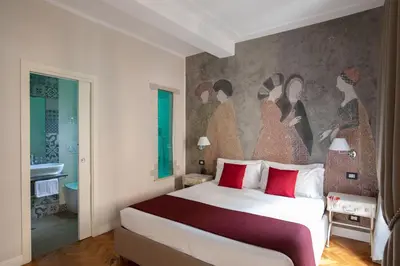 a bedroom with a bed with a painting on the wall at Spagna Secret Rooms in Rome