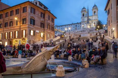 a group of people sitting on the steps of a building at Spagna Secret Rooms in Rome