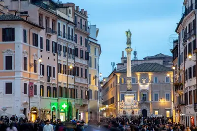 a crowd of people walking down a city street at Spagna Secret Rooms in Rome