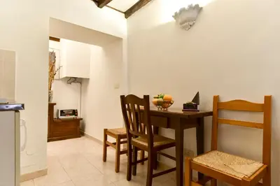 a kitchen and dining room with a table and chairs at Loft Pantheon in Rome