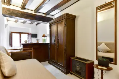 a bedroom with a bed and a large wooden cabinet at Loft Pantheon in Rome