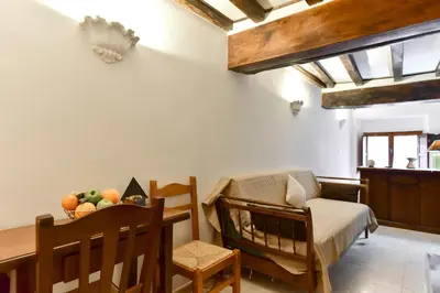 a bedroom with a crib and a table with a chair at Loft Pantheon in Rome