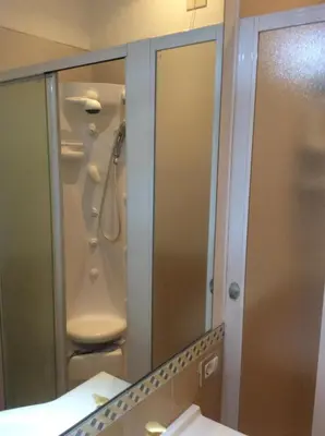a bathroom with a shower and a mirror at Elion in Rome