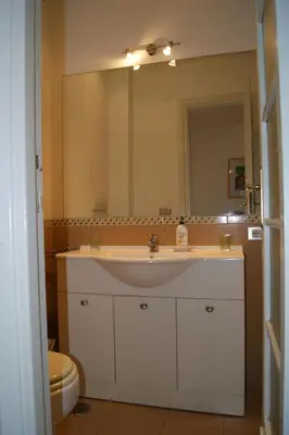 a bathroom with a sink and a large mirror at Elion in Rome