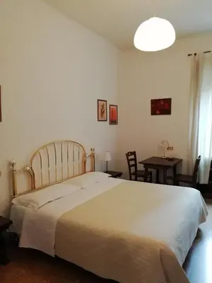 a bedroom with a large bed and a table at Elion in Rome