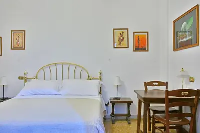 a bedroom with a bed and a desk and a table at Elion in Rome