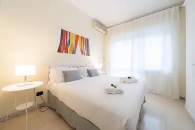 a bedroom with a large white bed with towels on it at VATICAN Gregory Apartment in Rome