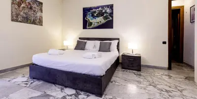 a bedroom with a large bed and two night stands at VATICAN Gregory Apartment in Rome