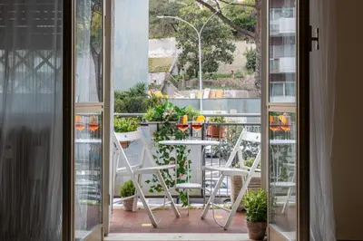 an open balcony with a table and chairs on a patio at VATICAN Gregory Apartment in Rome