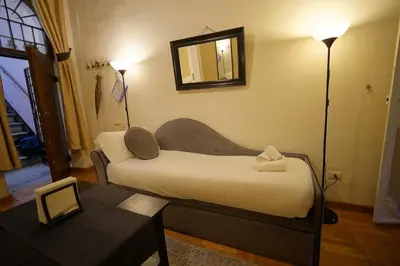 a bedroom with a bed with a mirror and a table at MGPgroup Guest House Navona 2 in Rome