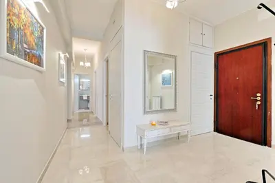 a hallway with a red door and a table at Oksana's Bernadette Apartment in Rome