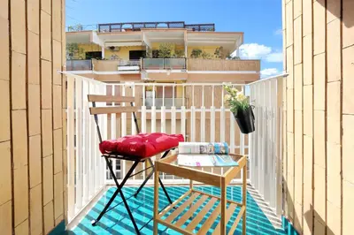 a pair of chairs and a table on a balcony at Oksana's Bernadette Apartment in Rome