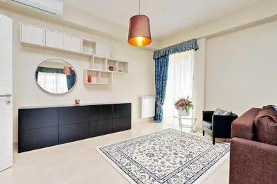 a living room with a couch and a mirror at Oksana's Bernadette Apartment in Rome