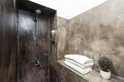 a bathroom with a shower and a pile of towels at Termini Central Inn in Rome