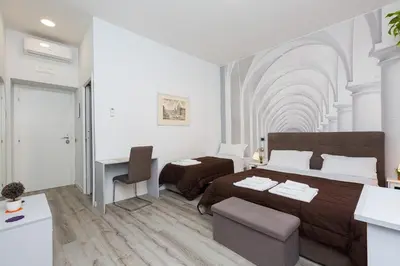 a bedroom with a bed and a desk in it at Termini Central Inn in Rome