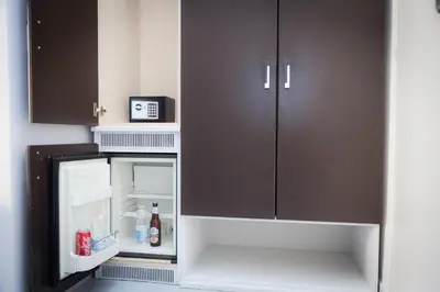 an empty refrigerator with its door open in a kitchen at Termini Central Inn in Rome