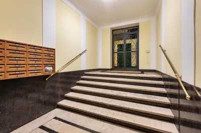 a set of stairs with a green door in a building at NOH Family Nest in Rome