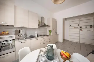 a kitchen with a table with a bowl of fruit on it at NOH Family Nest in Rome