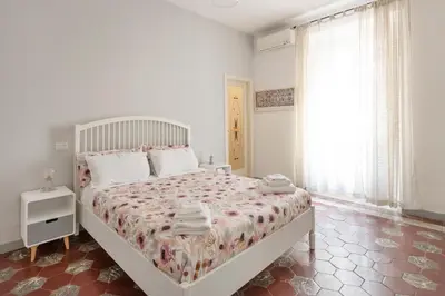 a bedroom with a large bed with towels on it at NOH Family Nest in Rome