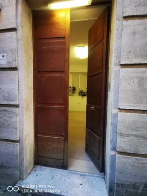 an empty hallway with two wooden doors in a house at Patrizi 2/a in Rome