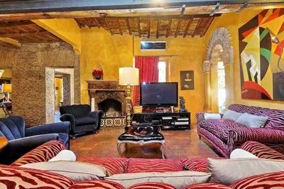 a living room with couches and a television and a fireplace at Spectacular Luxury Flat in Trastevere in Rome