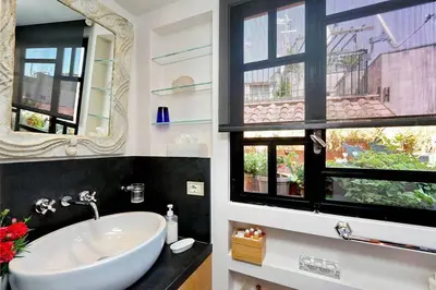 a bathroom with a sink and a mirror at Spectacular Luxury Flat in Trastevere in Rome