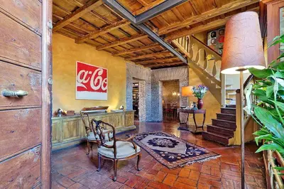 a coca cola sign on a wall in a room at Spectacular Luxury Flat in Trastevere in Rome