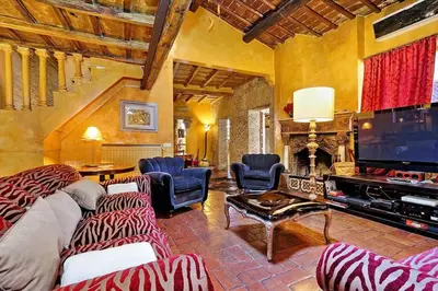a large living room with a large television and chairs at Spectacular Luxury Flat in Trastevere in Rome