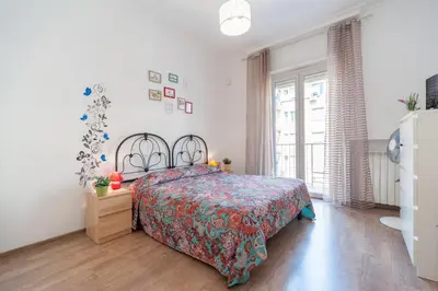 a bedroom with a bed with a colorful bedspread at Vatican Stemar Apartment in Rome