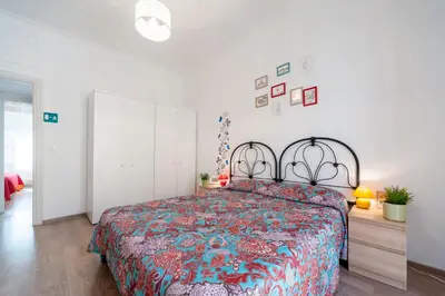 a bedroom with a large bed with a colorful bedspread at Vatican Stemar Apartment in Rome